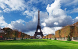 Eiffel Tower in Paris on a crisp autumn day with green lawns and colorful fall trees