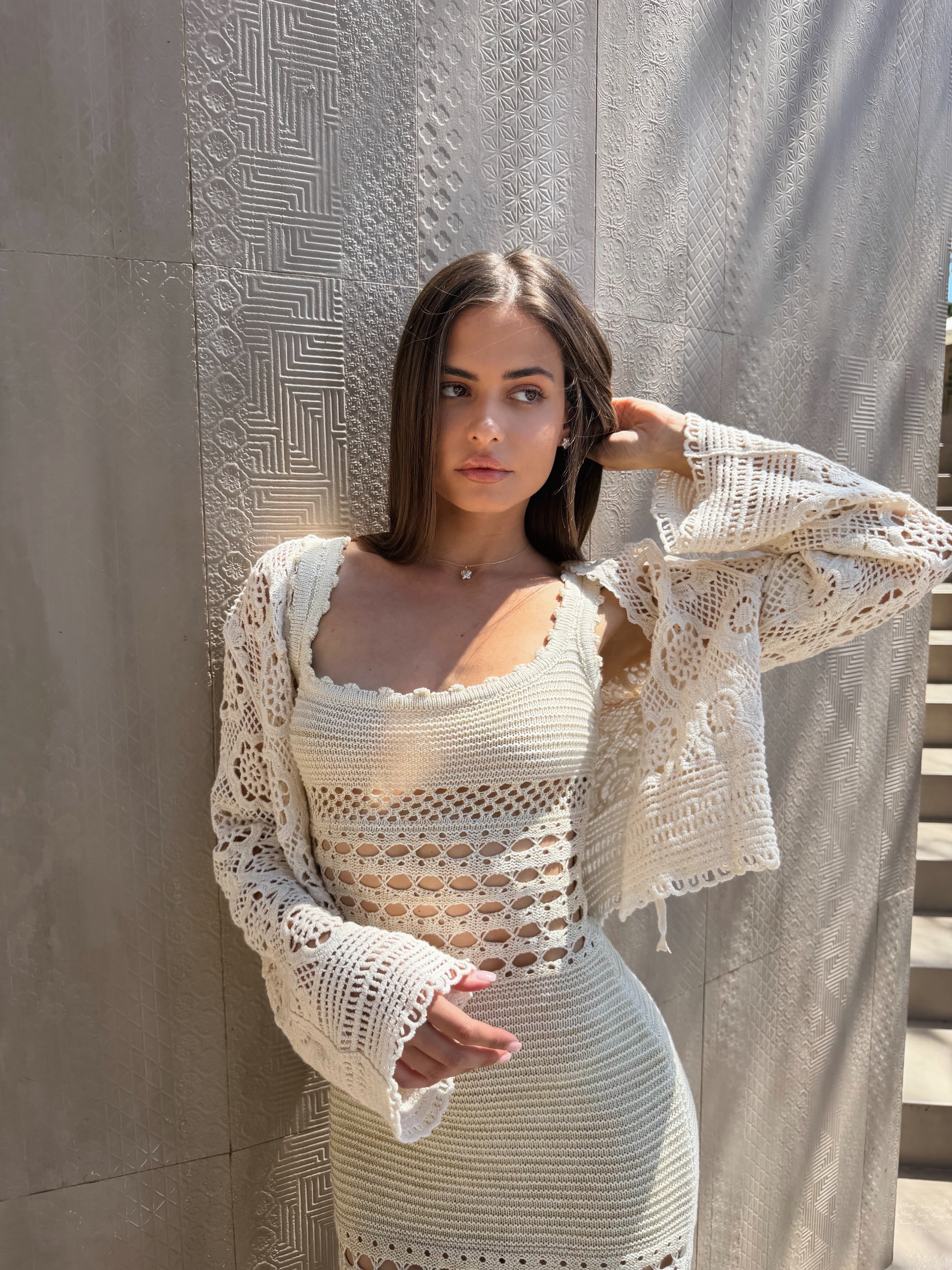 Front view of a model wearing a flattering ribbed knit dress in a curve hugging fit