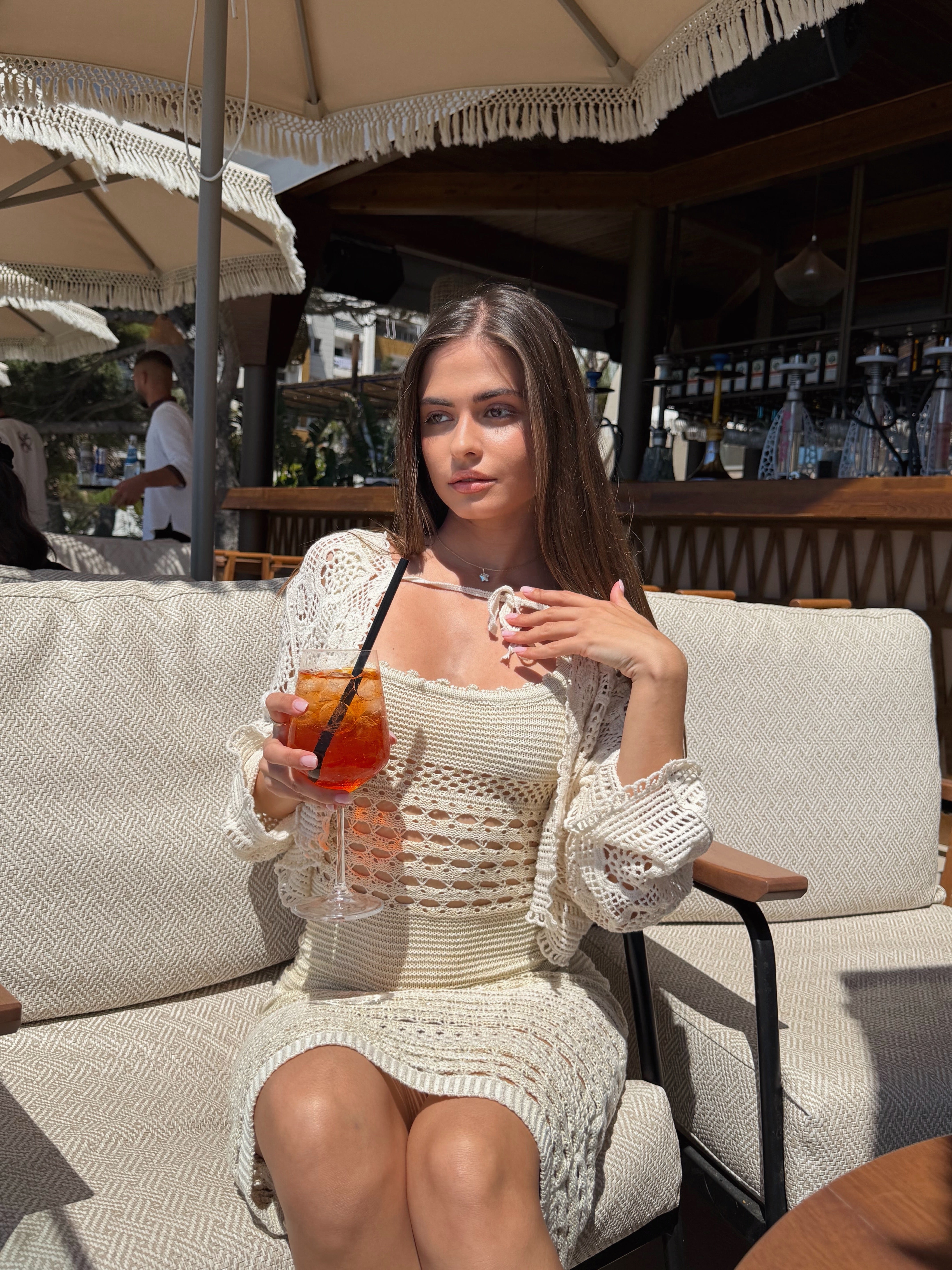 Front view of a model wearing a flattering ribbed knit dress in a curve hugging fit