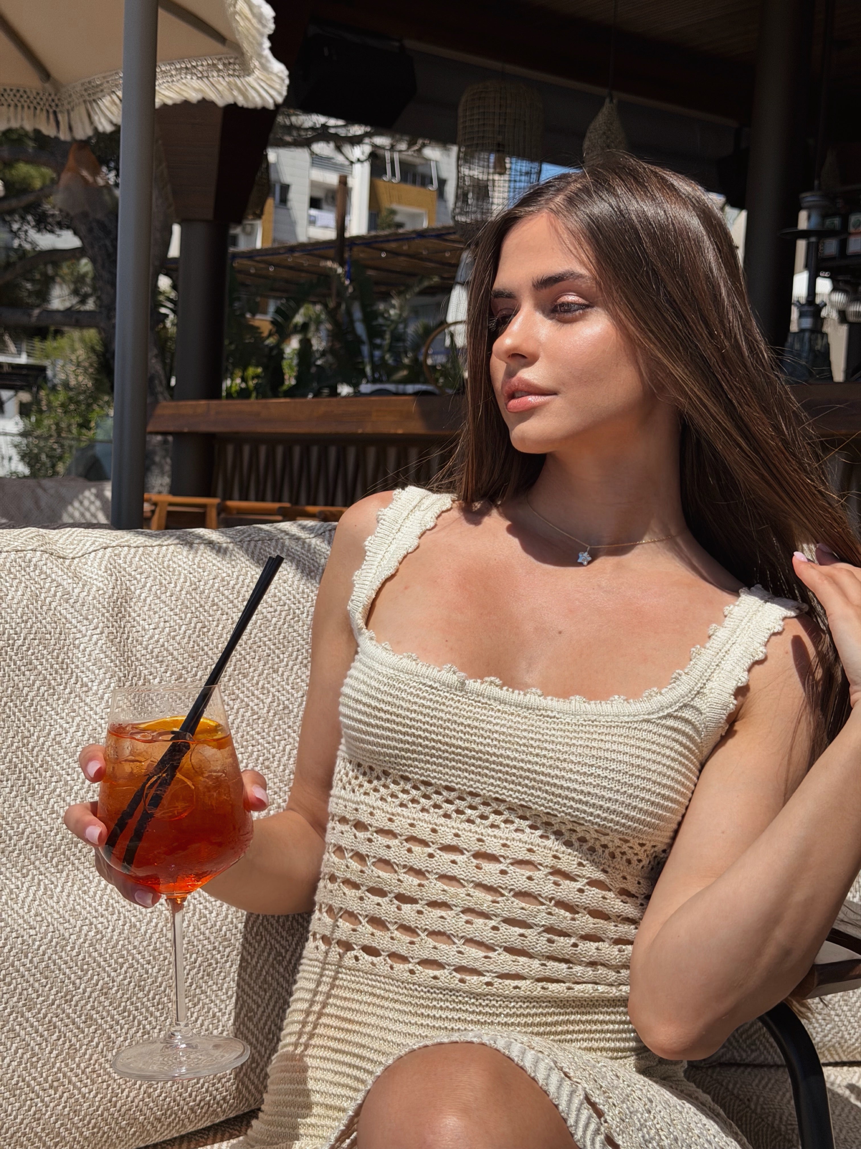 Front view of a model wearing a flattering ribbed knit dress in a curve hugging fit